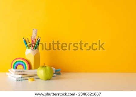 Embrace the joy of learning with this side-view snapshot of cheerful school supplies, penholder, and apple on yellow isolated backdrop, designed for text or ad placement, perfect for little learners Royalty-Free Stock Photo #2340621887