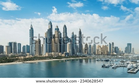The Palm Jumeirah archipelago opens the view on the coast of the mainland with sand beaches and skyline of Dubai Media City and Dubai Marina with skyscrapers, Dubai, UAE Royalty-Free Stock Photo #2340628547