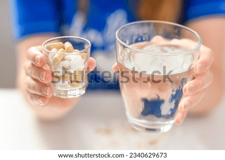 Take plenty of medicine and drink it with water Royalty-Free Stock Photo #2340629673