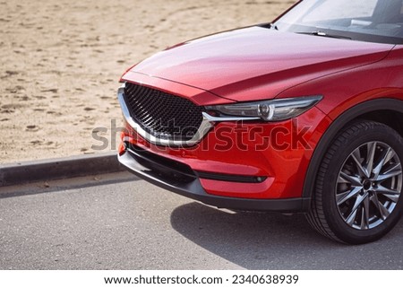 Red car. Detailed photo. Headlights, wheels, parts. Family car. City car. New car.  Royalty-Free Stock Photo #2340638939