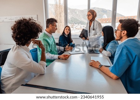 A medical team of doctors discussing at a meeting in the conference room. Royalty-Free Stock Photo #2340641955