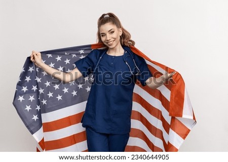 Smiling Doctor patriot with the flag of America on his back. The concept of the US medical system