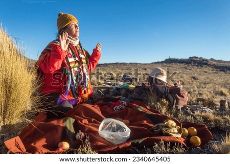 Quechua indigenous woman performing a ritual in the andean new year for the apus and the pachamama Royalty-Free Stock Photo #2340645405