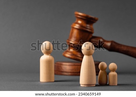 Wooden toy family and judge mallet. Family divorce concept Royalty-Free Stock Photo #2340659149