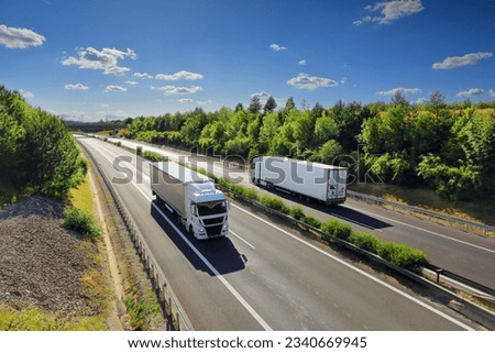 Cargo truck driving through landscape at sunset Royalty-Free Stock Photo #2340669945