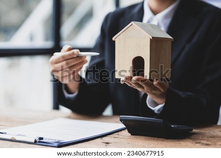 Businesswoman, real estate agent working on paperwork in the office.
