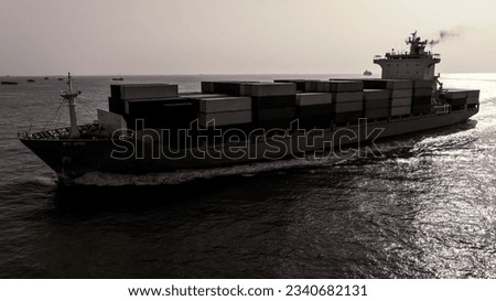 black and white of cargo container ship sailing full speed in sea and over background to import export goods and distributing products to dealer and consumers worldwide, by container ship Transport