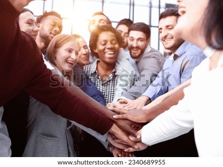 Large business team showing unity with their hands together Royalty-Free Stock Photo #2340689955