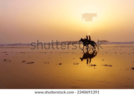Sunset view with silhouette of horses and riders on the beach of Essaouira (Mogador), Morocco Royalty-Free Stock Photo #2340691391