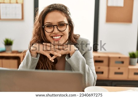 Young beautiful hispanic woman business worker using laptop working at office Royalty-Free Stock Photo #2340697275