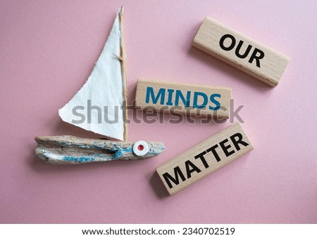 Our Minds Matter symbol. Concept words Our Minds Matter on wooden blocks. Beautiful pink background with boat. Psychological social and Our Minds Matter concept. Copy space. Concept word