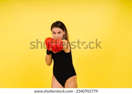 Portrait of a female mixed martial arts fighter with a bandage and gloves on her hands.