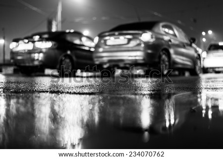 Rainy day in the city at night, traffic jam on the street