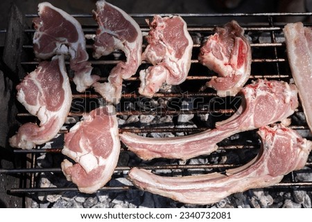 Lamb chops in a grill, typical Spanish food to eat with some friends and family. Weekend menu to cook in a camping