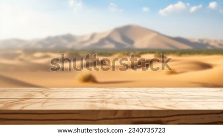 The empty wooden brown table top with blur background of desert dune mountain. Exuberant image.