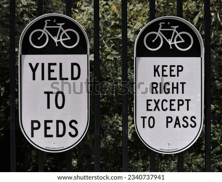 bicycle sign (yield to peds and keep right except to pass) on a fence by the entrance to the george washington bridge (gwb) in manhattan, new york city (cycling, biking, riding, bike, road cycle path)