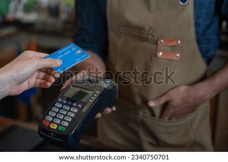Woman use credit card pay money online in cafe restaurant with a digital payment without cash. accumulate discount. E wallet, technology, pay online, credit card, bank app. daily life payment