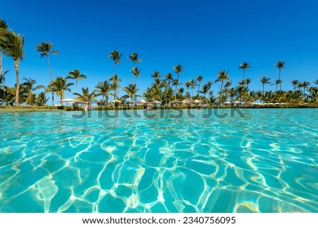 Swimming pool and palm trees in luxury resort at Punta Cana in the Dominican Republic Royalty-Free Stock Photo #2340756095