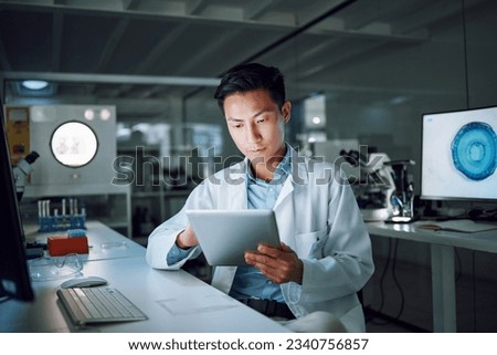 Tablet, planning and scientist with digital innovation, data and reading in laboratory. Asian man, doctor and information technology for futuristic medical research with pharma healthcare study Royalty-Free Stock Photo #2340756857