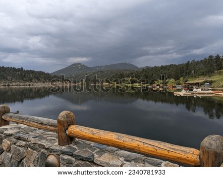 Evergreen lake in Colorado with the mountains rising in the background. Royalty-Free Stock Photo #2340781933
