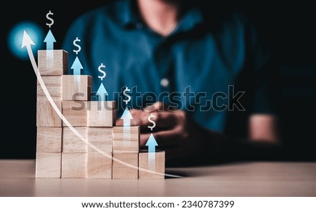 Finance and investment, financial and invest,  growth, saving, wealth, investor, asset. Wooden cube asset is growing to take benefit. Finance investment financial. Dollar symbol and arrow point up.