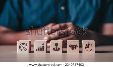 Investment for ultimate goals, stock and trade, business development, business cooperation and timings concept. Hand setting target wooden cube block with business strategy plan.