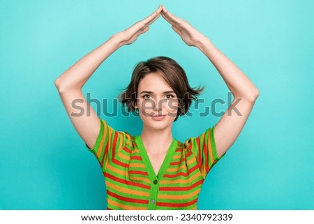 Photo of positive pretty lady arms demonstrate roof above head gesture isolated on turquoise color background Royalty-Free Stock Photo #2340792339