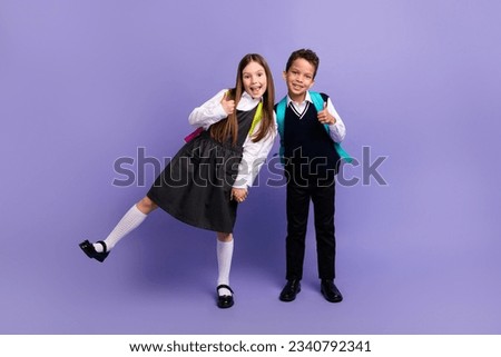 Photo of funny schoolkids enjoy season school discounts make thumb up like isolated bright color background Royalty-Free Stock Photo #2340792341