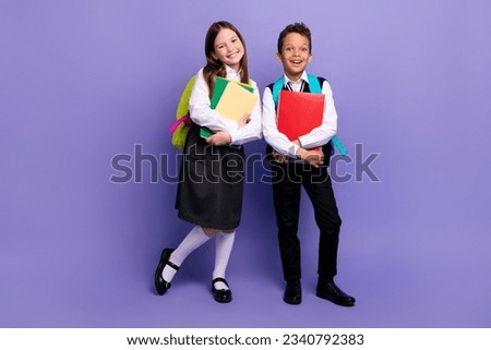 Photo of two school kids ready for first day buying supply for learning isolated bright color background Royalty-Free Stock Photo #2340792383