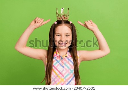 Photo of cheerful charming girl wear trendy clothes two arm pointing herself precious crown isolated on green color background