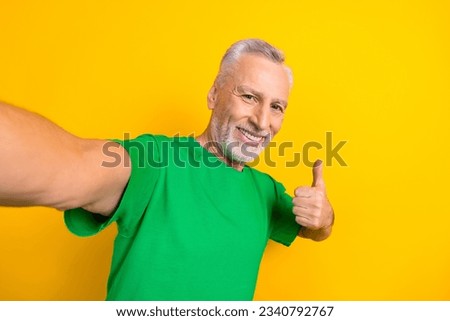 Photo of positive grandfather take selfie hand finger demonstrate thumb up approval isolated on yellow color background