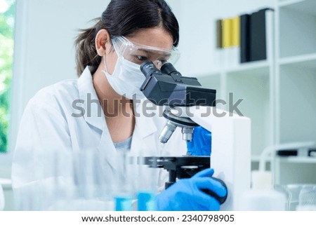 Medical Research Laboratory. Female Scientist Using Microscope to analyze substance or liquid, virus. Professionals Working in Advanced Scientific Lab doing Medicine, Vaccine, Biotechnology test
