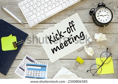 Kick-off meeting Message. text on torn paper on wooden background near white keyboard Royalty-Free Stock Photo #2340806585