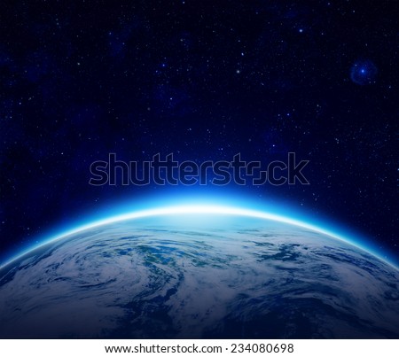 Blue Planet Earth sunrise over cloudy ocean with stars in the sky, An eclipse of the Sun by the world make rising sun in space can use for background - Elements of this image furnished by NASA