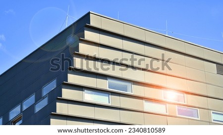Modern office building in the city with windows and  steel and aluminum panels wall. Contemporary commercial architecture, vertical converging geometric lines.  