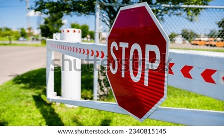Close up from stop sign in summer day on entrance gate