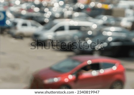 Abstract blurred outdoor parking, sales retail, season sales, sunny summer day, at peak hour
