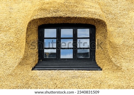 New thatch roof over house with dormer window in Denmark, Europe, thatched roof Royalty-Free Stock Photo #2340831509
