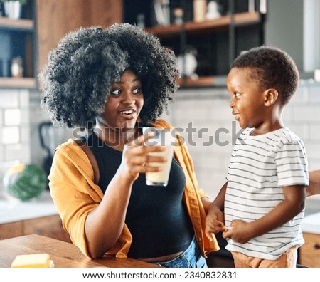 Portrait of mother, father and son  preparing and eating breakfast and drinking milk  in the kitchen at home Royalty-Free Stock Photo #2340832831