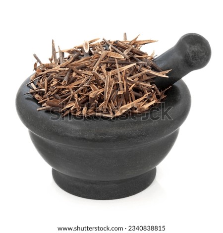 Chinese honey locust herb used in herbal medicine in a marble mortar with pestle over white background. Zao jiao ci.