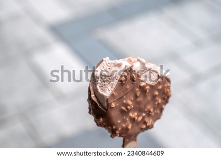 Choco-Hazelnut Bliss Classic milk chocolate ice cream. stock photos with a blurred public place as the background
