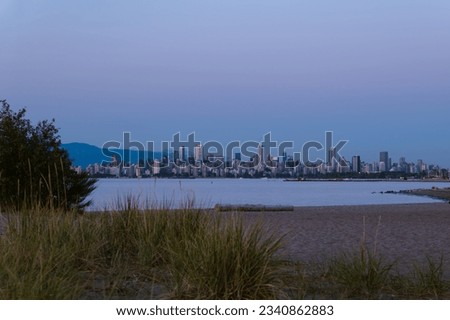 Vancouver skyline from Spanish Banks Beach at blue hour.