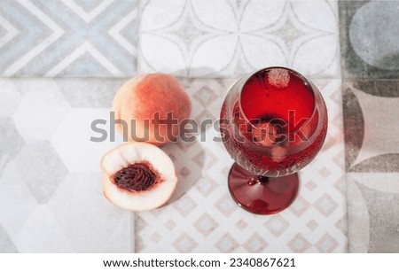 Glass with cold drink and peaches on vintage tile background. Top view. Selective focus.