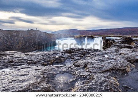 A frozen landscape of a waterfall in Iceland