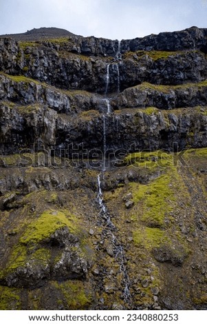 An icelandic rocky waterfall with green moss