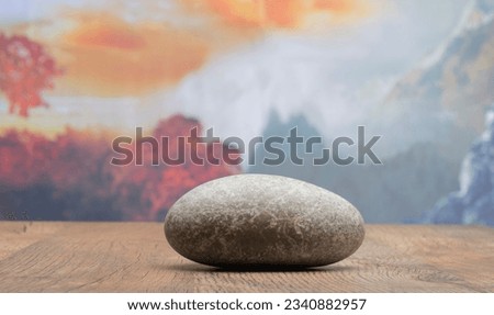 autumn podium with zen stones against autumn nature and sky for product presentation background