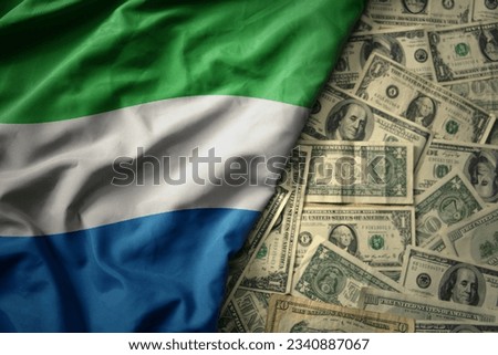 big colorful waving national flag of sierra leone on a american dollar money background. finance concept
