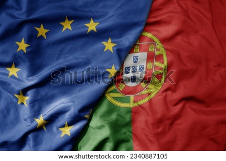 big waving realistic national colorful flag of european union and national flag of portugal . macro