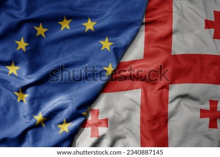 big waving realistic national colorful flag of european union and national flag of georgia . macro Royalty-Free Stock Photo #2340887145