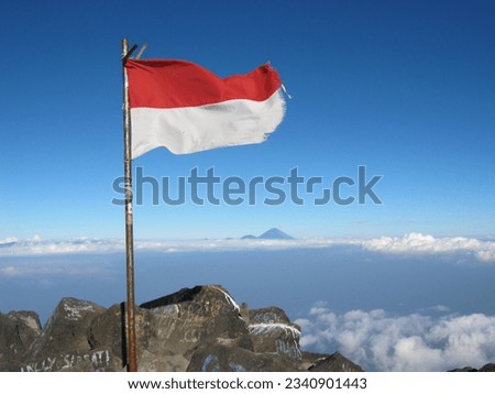 Indonesian flag, red and white fluttering over the top of the mountain. The photo was taken by Willem Tasiam, a marathon climber